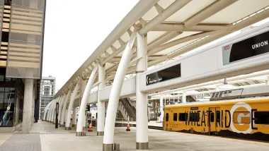 A yellow RTD train at platform at Union Station in Denver, Colorado.